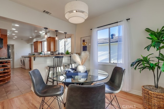 3562 N Studebaker, Long Beach, CA 90808 - dining area featuring plenty of natural light, washer / dryer, light wood finished floors, baseboards, and recessed lighting
