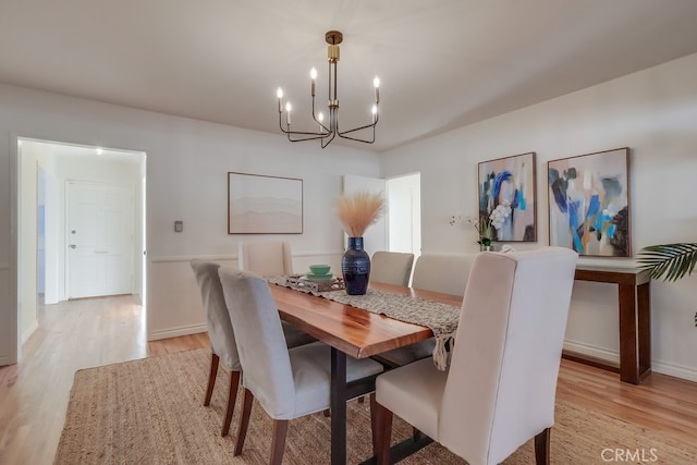3562 N Studebaker, Long Beach, CA 90808 - dining room featuring a chandelier, light wood-style floors, and baseboards