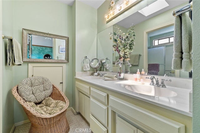 73 Mockingbird Ln, Templeton, CA 93465 - bathroom featuring double vanity, a skylight, and baseboards