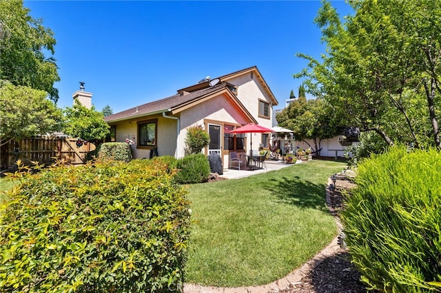 73 Mockingbird Ln, Templeton, CA 93465 - rear view of house with stucco siding, a patio area, and a chimney