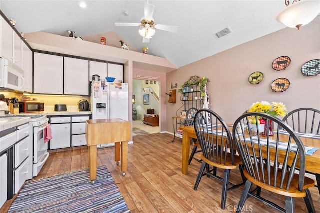 73 Mockingbird Ln, Templeton, CA 93465 - kitchen with white appliances, tile counters, white cabinetry, ceiling fan, and lofted ceiling