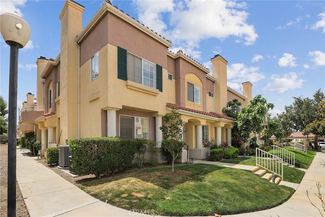 18102 Flynn Dr Unit 4602, Canyon Country, CA 91387 - mediterranean / spanish-style house with stucco siding, a front yard, central AC unit, a chimney, and a tiled roof