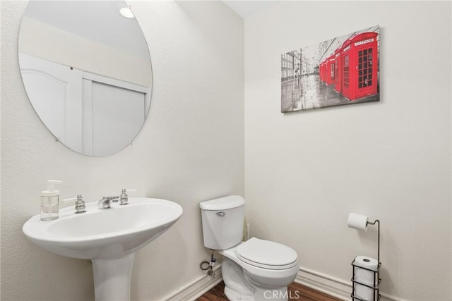 18102 Flynn Dr Unit 4602, Canyon Country, CA 91387 - half bathroom with wood finished floors, toilet, baseboards, and a sink