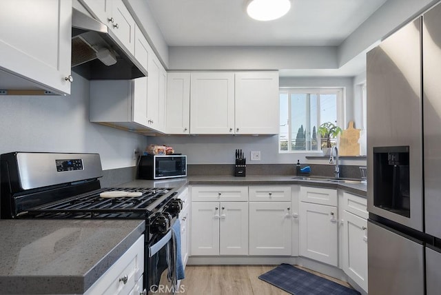 158 W Del Amo Blvd, Long Beach, CA 90805 - kitchen featuring stainless steel appliances, under cabinet range hood, white cabinetry, and light wood-style flooring
