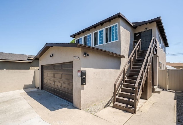 158 W Del Amo Blvd, Long Beach, CA 90805 - view of front of home with stucco siding, stairs, driveway, and an attached garage