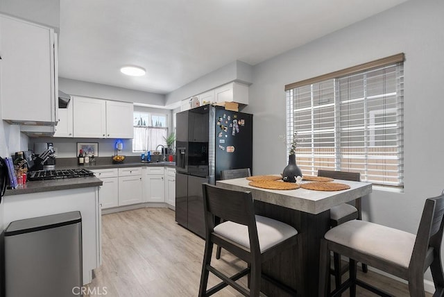 158 W Del Amo Blvd, Long Beach, CA 90805 - kitchen with stainless steel refrigerator with ice dispenser, dark countertops, white cabinets, light wood-type flooring, and exhaust hood