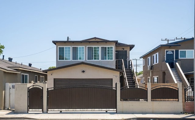 158 W Del Amo Blvd, Long Beach, CA 90805 - view of front of house with a gate, an attached garage, a fenced front yard, and stucco siding