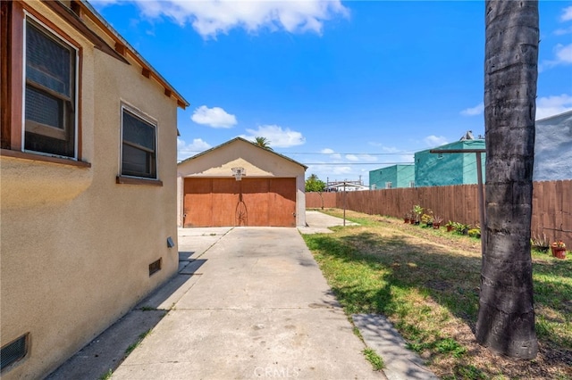 1415 W 104th St, Los Angeles, CA 90047 - view of yard with a garage and a patio area