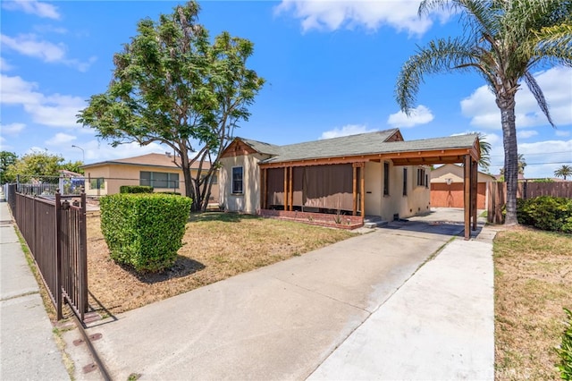 1415 W 104th St, Los Angeles, CA 90047 - ranch-style house with concrete driveway, stucco siding, and an attached carport