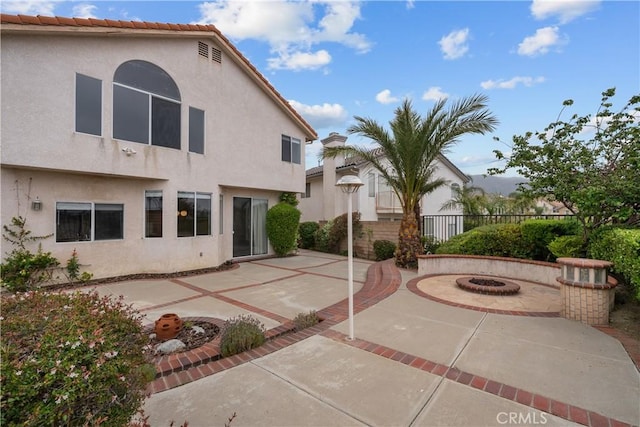 19752 Sierra Meadows Ln, Porter Ranch, CA 91326 - back of house with an outdoor fire pit, a patio, and stucco siding