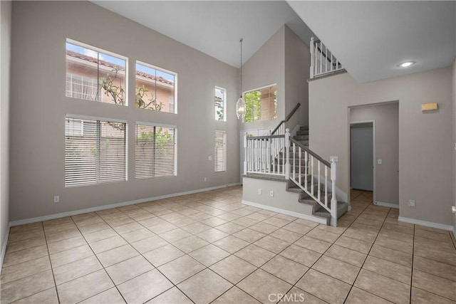 19752 Sierra Meadows Ln, Porter Ranch, CA 91326 - unfurnished living room featuring high vaulted ceiling, stairway, and tile patterned flooring