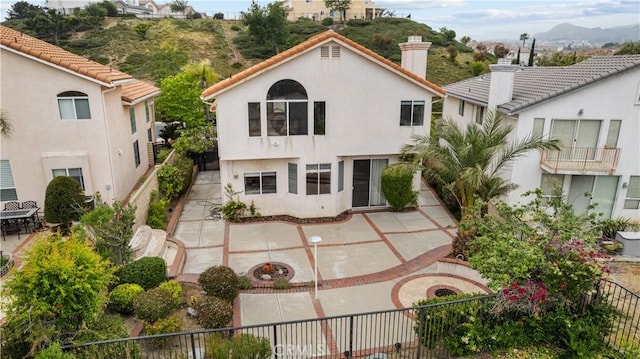 19752 Sierra Meadows Ln, Porter Ranch, CA 91326 - rear view of house featuring a chimney, a patio, stucco siding, and a mountain view