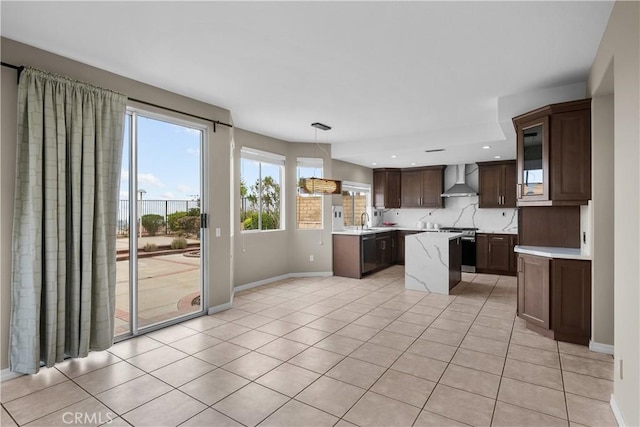 19752 Sierra Meadows Ln, Porter Ranch, CA 91326 - kitchen featuring stainless steel stove, wall chimney range hood, light countertops, dark brown cabinetry, and a kitchen island