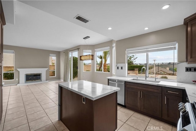 19752 Sierra Meadows Ln, Porter Ranch, CA 91326 - kitchen featuring appliances with stainless steel finishes, light tile patterned floors, a center island, dark brown cabinetry, and recessed lighting