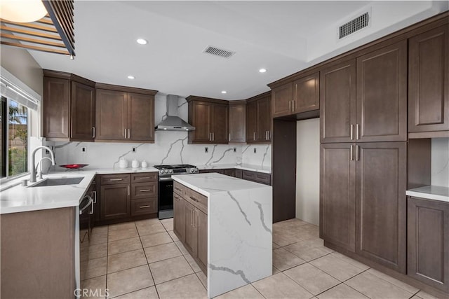 19752 Sierra Meadows Ln, Porter Ranch, CA 91326 - kitchen featuring gas stove, wall chimney range hood, light tile patterned flooring, recessed lighting, and dark brown cabinetry
