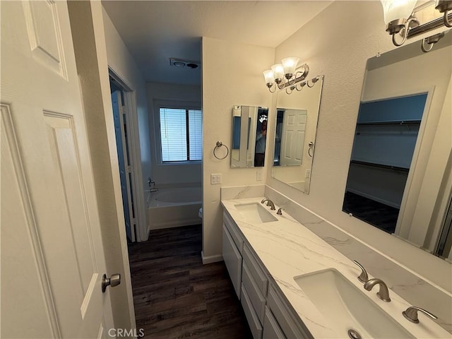 15332 Tuscola Rd, Apple Valley, CA 92307 - bathroom featuring wood finished floors, double vanity, and a tub to relax in