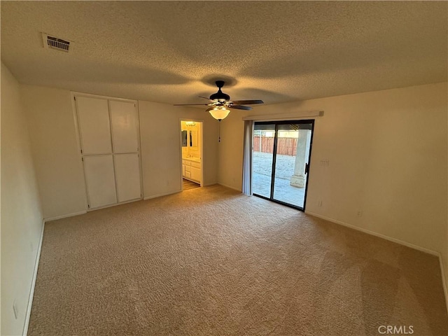 15332 Tuscola Rd, Apple Valley, CA 92307 - unfurnished bedroom with access to exterior, a textured ceiling, light colored carpet, baseboards, and ceiling fan