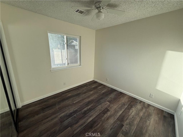 15332 Tuscola Rd, Apple Valley, CA 92307 - unfurnished bedroom featuring a textured ceiling, dark wood-style floors, baseboards, and a ceiling fan