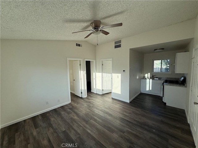 15332 Tuscola Rd, Apple Valley, CA 92307 - unfurnished living room featuring a ceiling fan, lofted ceiling, dark wood finished floors, baseboards, and a textured ceiling