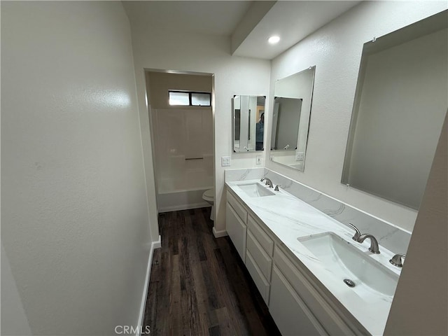 15332 Tuscola Rd, Apple Valley, CA 92307 - full bath with wood finished floors, toilet, double vanity, and bathtub / shower combination