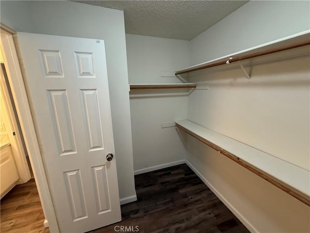 15332 Tuscola Rd, Apple Valley, CA 92307 - walk in closet featuring dark wood-type flooring