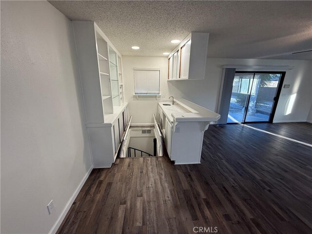 15332 Tuscola Rd, Apple Valley, CA 92307 - laundry area featuring a textured ceiling, a sink, baseboards, dark wood-style floors, and recessed lighting
