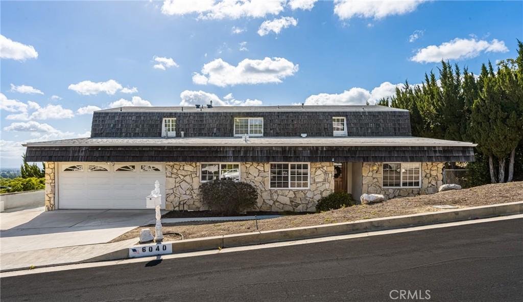 6040 Pat Ave, Woodland Hills, CA 91367 - view of front of property with stone siding, driveway, and a garage