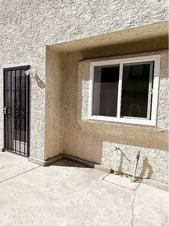410 Russell Ave Unit C, Monterey Park, CA 91755 - doorway to property featuring stucco siding and a patio area