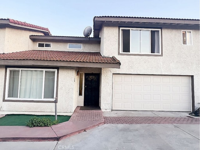 410 Russell Ave Unit C, Monterey Park, CA 91755 - view of front of home featuring a garage, stucco siding, a tiled roof, and decorative driveway