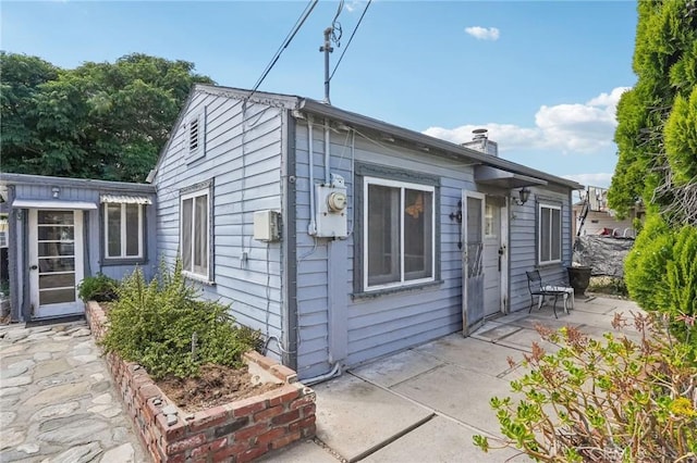 1385 Turquoise Ave, Mentone, CA 92359 - rear view of house featuring a patio and a chimney