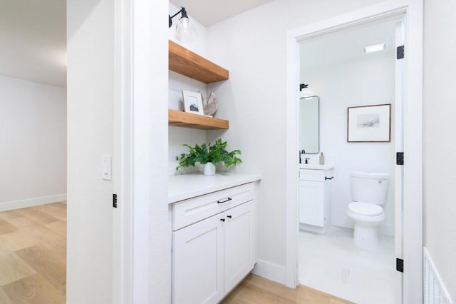 4161 Rhodes Way, Oceanside, CA 92056 - bathroom featuring toilet, wood finished floors, vanity, and baseboards