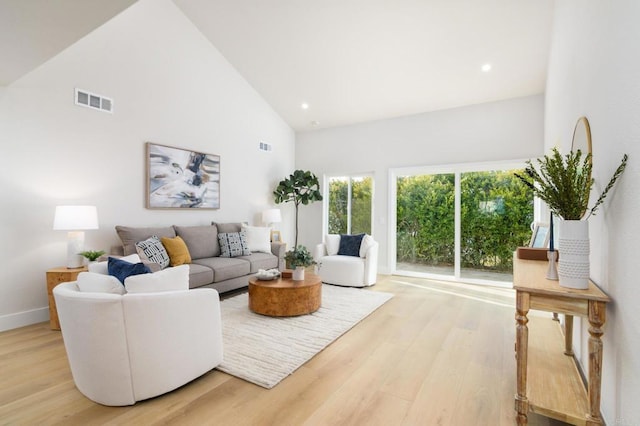 4161 Rhodes Way, Oceanside, CA 92056 - living area with high vaulted ceiling, light wood finished floors, baseboards, and recessed lighting