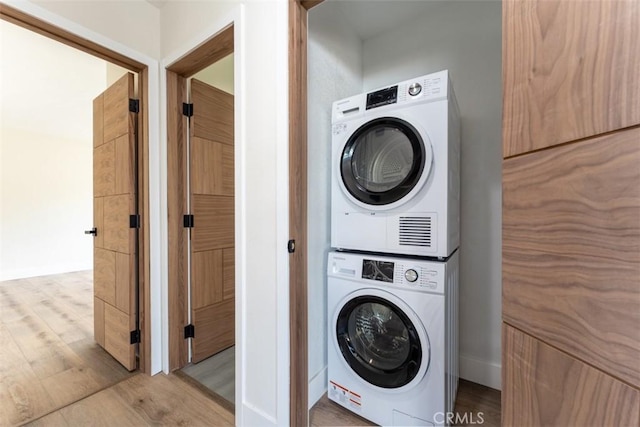 60468 Latham Trl, Joshua Tree, CA 92252 - laundry room featuring stacked washer / drying machine and wood finished floors