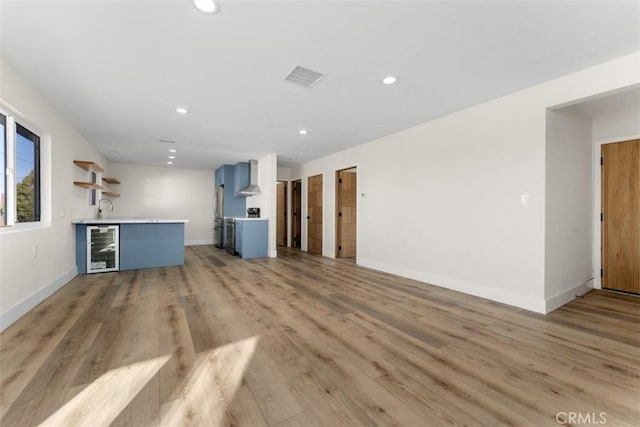 60468 Latham Trl, Joshua Tree, CA 92252 - unfurnished living room with beverage cooler, recessed lighting, baseboards, light wood-style floors, and bar area