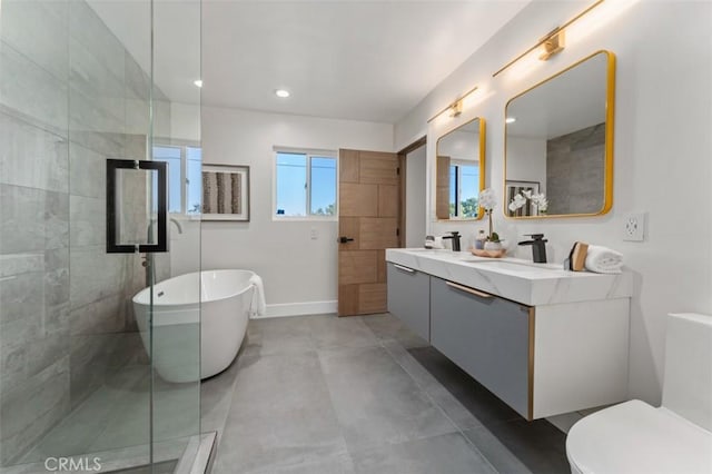 60468 Latham Trl, Joshua Tree, CA 92252 - bathroom with a freestanding tub, double vanity, tiled shower, recessed lighting, and toilet