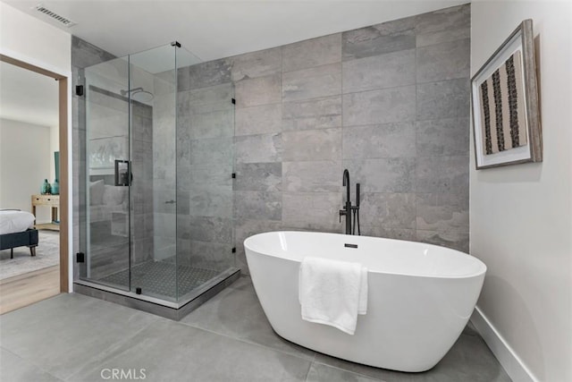 60468 Latham Trl, Joshua Tree, CA 92252 - ensuite bathroom featuring a shower stall, a freestanding tub, tile walls, and baseboards