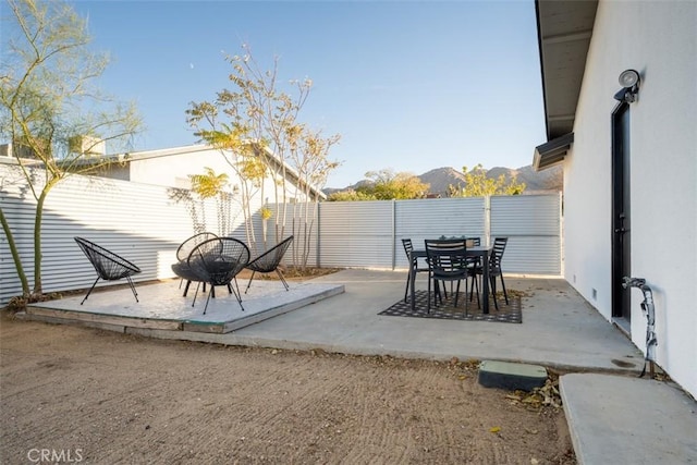 60468 Latham Trl, Joshua Tree, CA 92252 - fenced backyard with a patio, outdoor dining space, and a mountain view