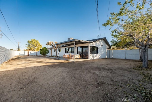 60468 Latham Trl, Joshua Tree, CA 92252 - view of front facade featuring a patio, a fenced backyard, and stucco siding