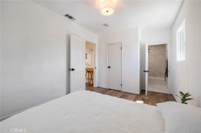 4142 Mercury Ave, Los Angeles, CA 90031 - bedroom featuring wood finished floors, baseboards, and ensuite bath