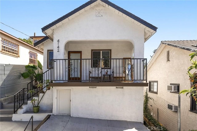 4142 Mercury Ave, Los Angeles, CA 90031 - back of house with stucco siding, a wall mounted air conditioner, a porch, and stairway