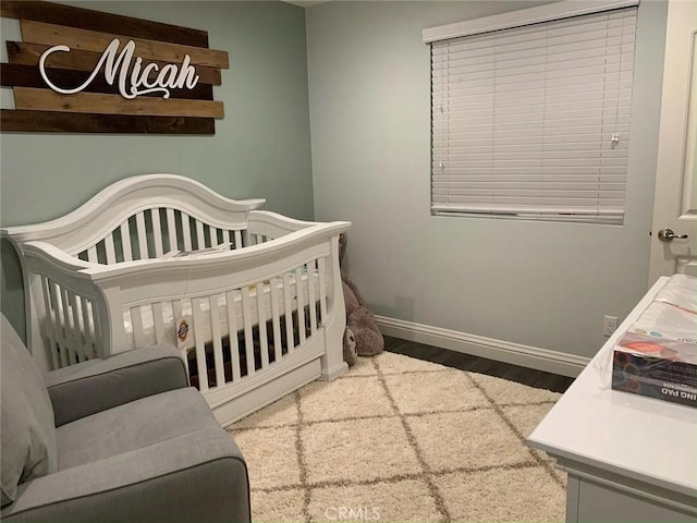 3235 E Olympic Dr, Ontario, CA 91762 - bedroom with wood finished floors, baseboards, and a nursery area
