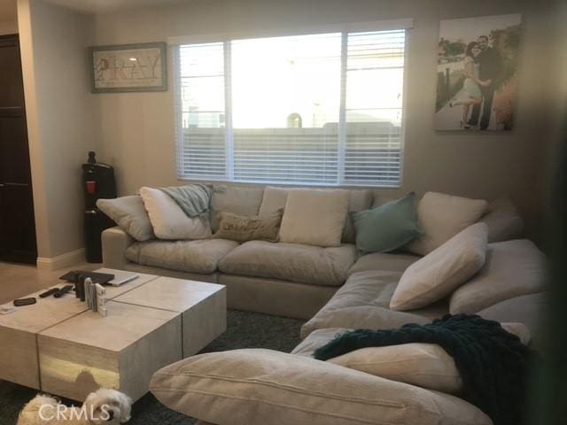 3235 E Olympic Dr, Ontario, CA 91762 - living area featuring plenty of natural light and baseboards