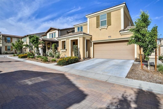 3235 E Olympic Dr, Ontario, CA 91762 - townhome / multi-family property with an attached garage, stucco siding, driveway, and a tile roof