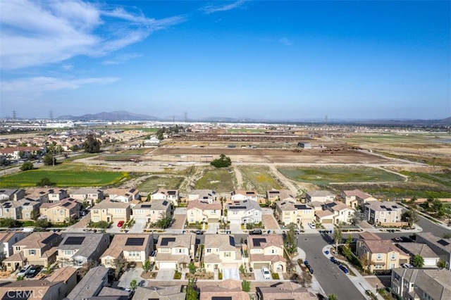 3235 E Olympic Dr, Ontario, CA 91762 - aerial view of property and surrounding area featuring a mountainous background and nearby suburban area