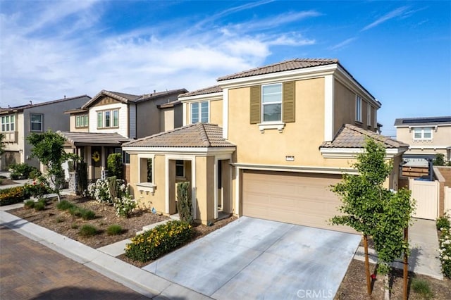 3235 E Olympic Dr, Ontario, CA 91762 - townhome / multi-family property featuring a tiled roof, an attached garage, stucco siding, and driveway