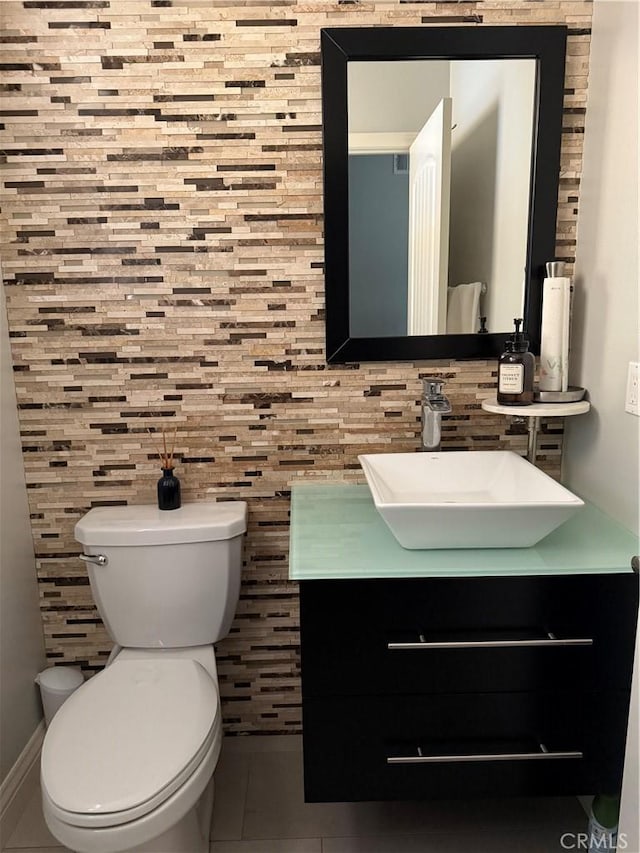 3235 E Olympic Dr, Ontario, CA 91762 - half bathroom with vanity, toilet, decorative backsplash, and tile patterned floors
