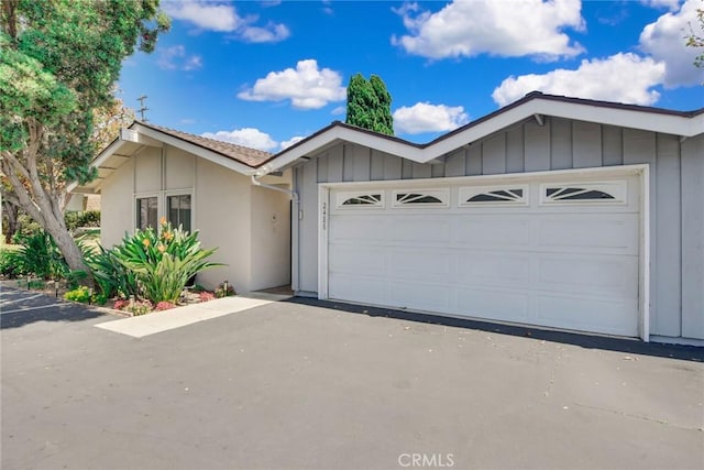 2486 Napoli Way, Costa Mesa, CA 92627 - ranch-style home featuring driveway, a garage, board and batten siding, and stucco siding