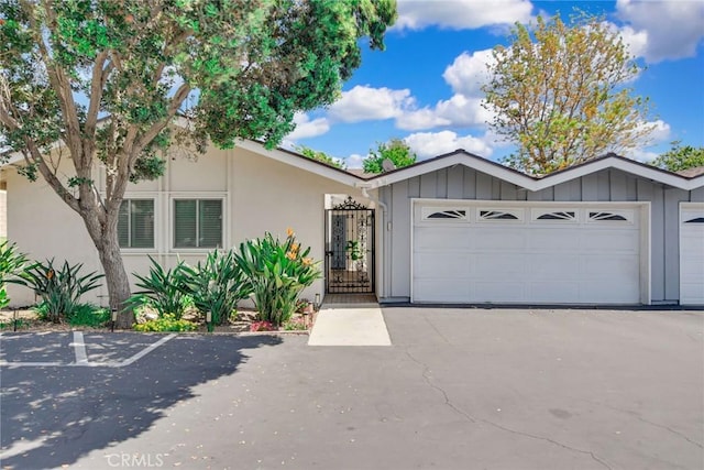 2486 Napoli Way, Costa Mesa, CA 92627 - view of front facade with stucco siding, board and batten siding, and an attached garage