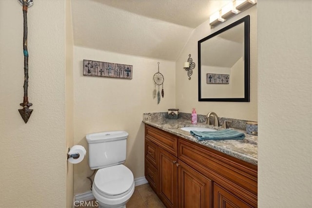 6600 Montresor Pl, Rancho Cucamonga, CA 91737 - half bathroom with vanity, toilet, vaulted ceiling, and tile patterned flooring
