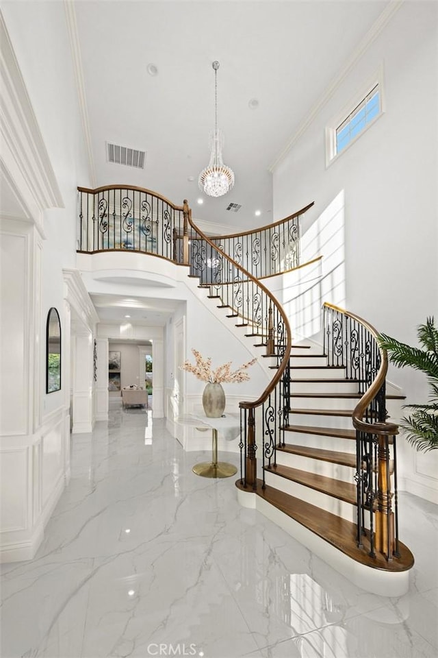 4840 Temple City Blvd, Temple City, CA 91780 - stairway with a towering ceiling, marble tiled flooring, healthy amount of natural light, ornamental molding, and arched walkways